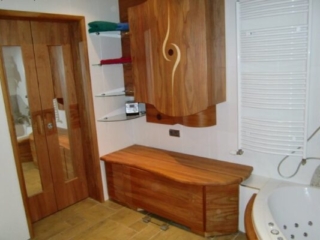 Badezimmer in Kirsche mit geschwungenen Schränken